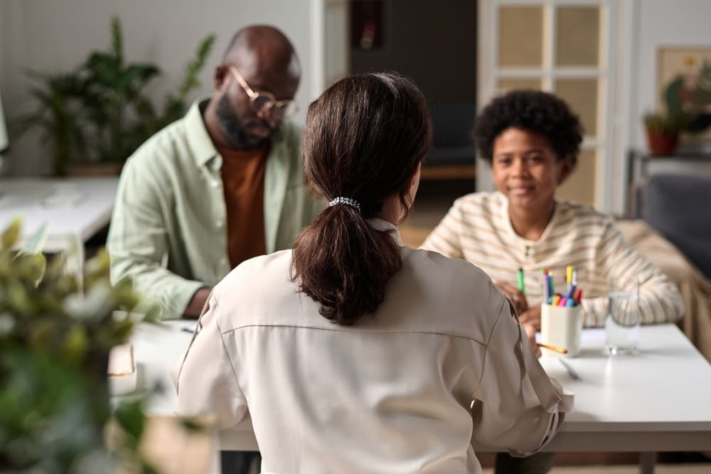 “Family law consultation with a solicitor discussing spousal maintenance with a parent and child at a desk.”