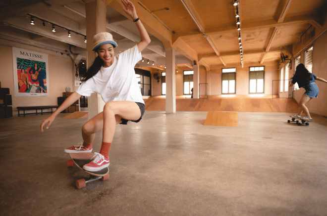 two people skating in an indoor skate park