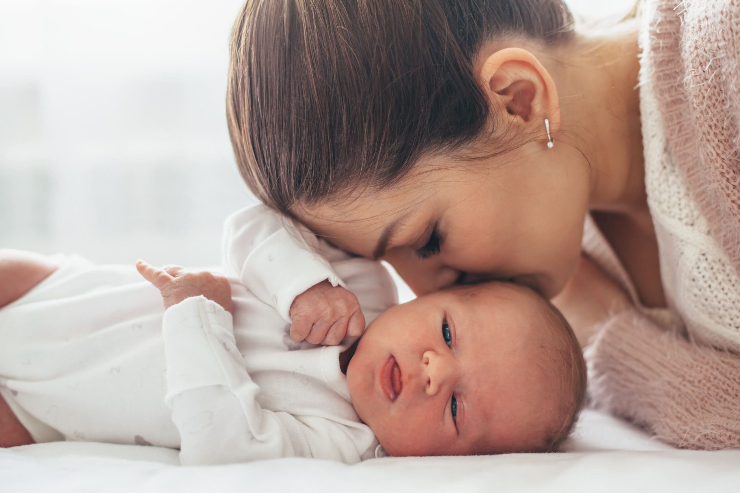 Mother kissing baby