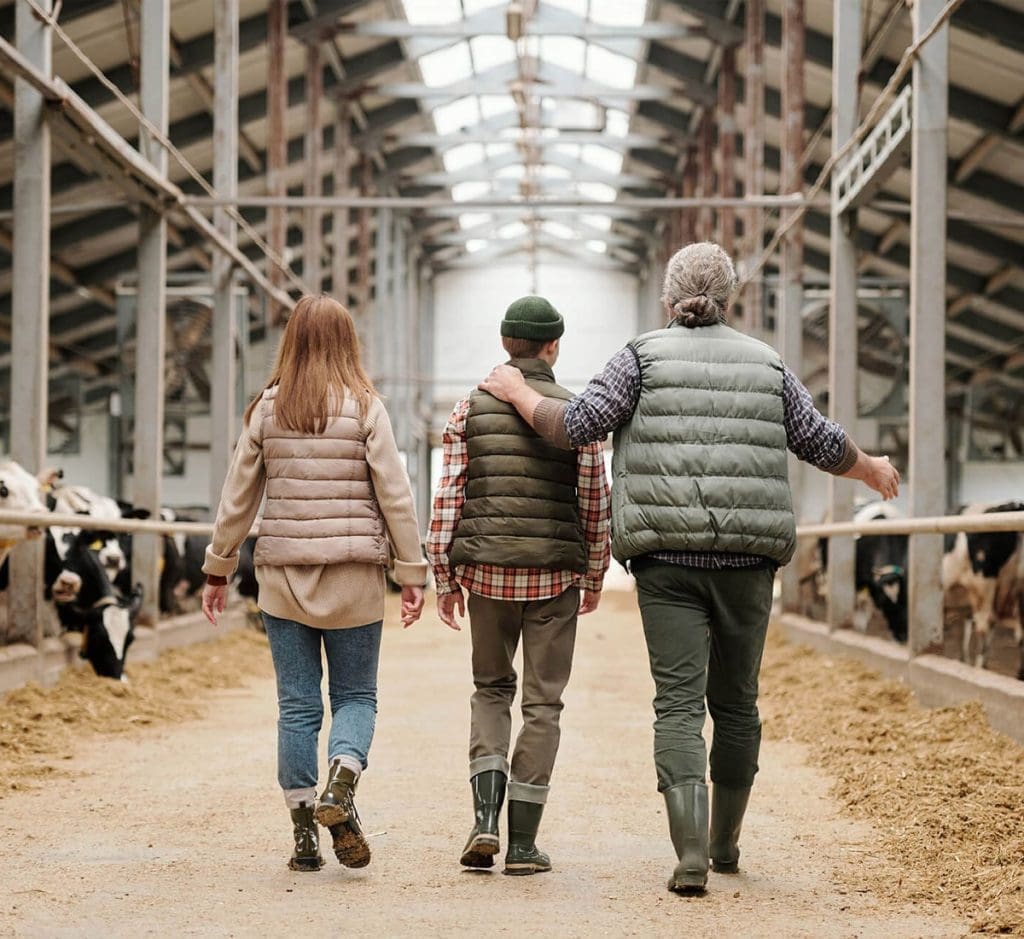 Farming Family Walking Through A Barn