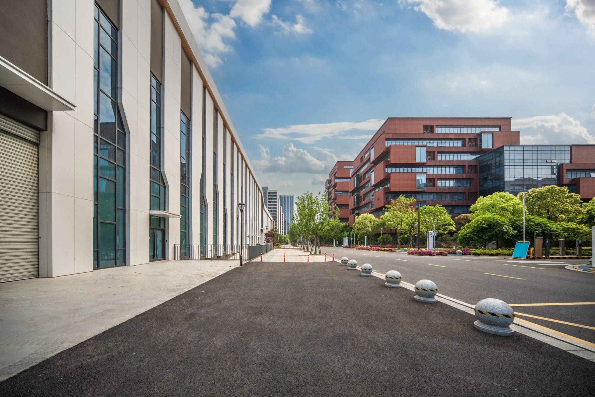 Modern commercial property buildings in a business district, showcasing sleek architectural design and well-maintained surroundings.