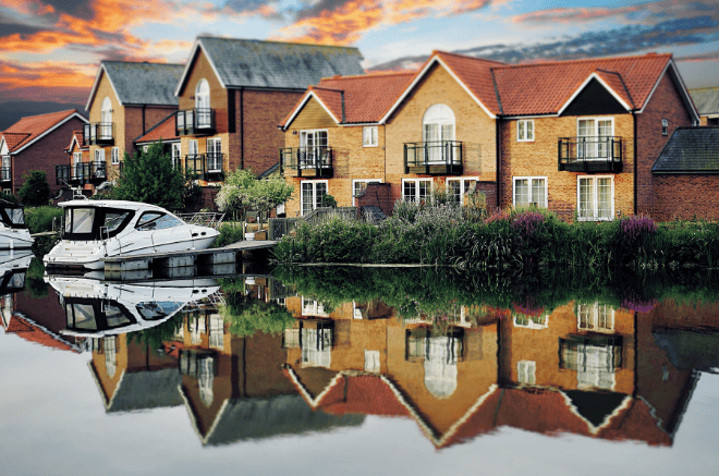 lake side property sale, houses next to a lake with boats on the water